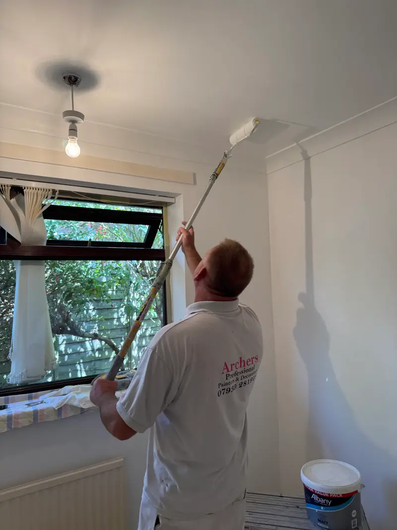 Archers decorator rolling a ceiling