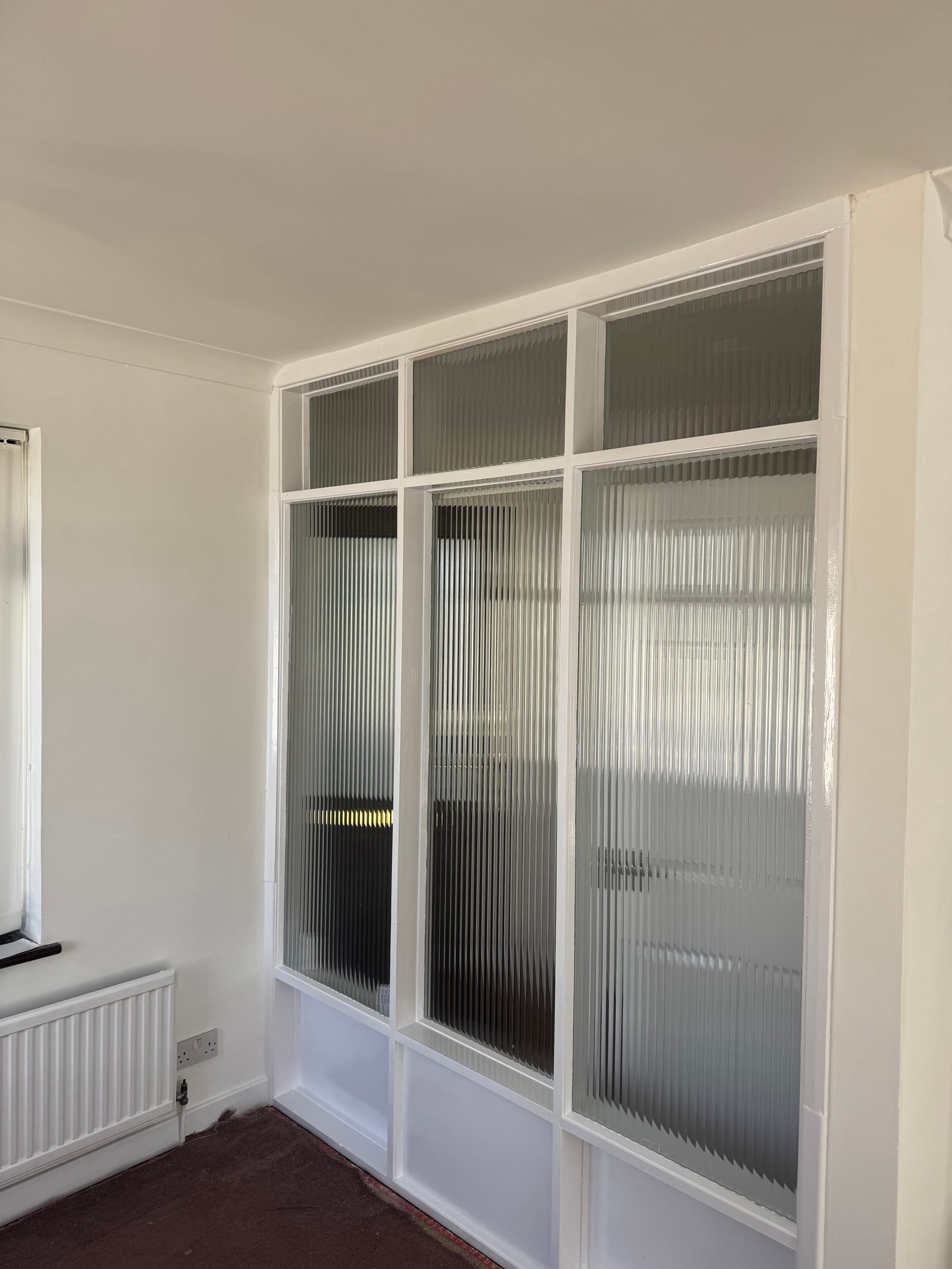 Glazed partition and woodwork finished in fresh white gloss