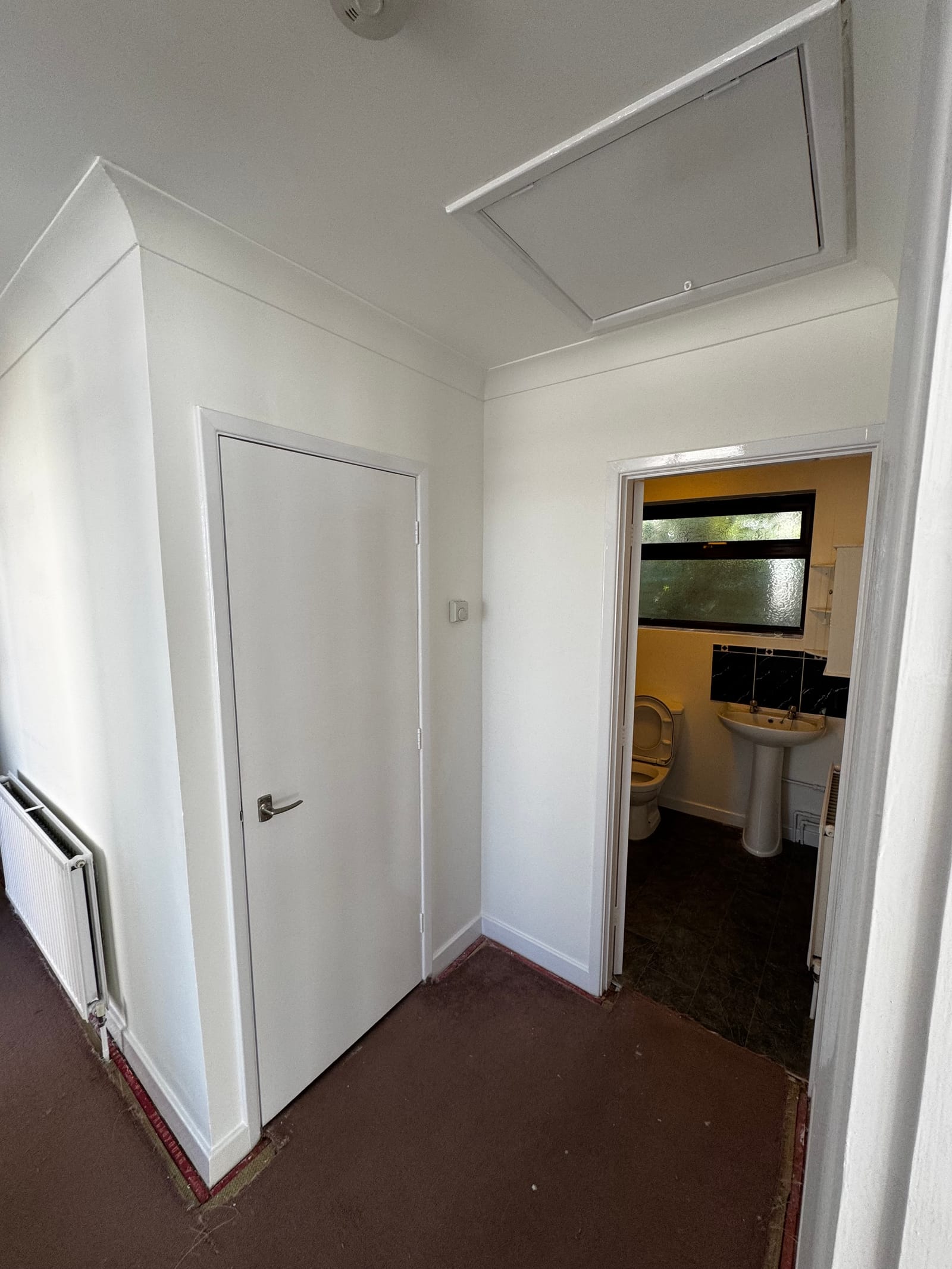 Freshly painted hallway with crisp white woodwork by Archers