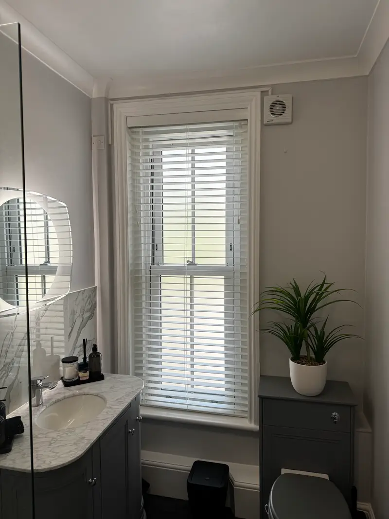 Refurbished bathroom with marble tiling and fresh paintwork