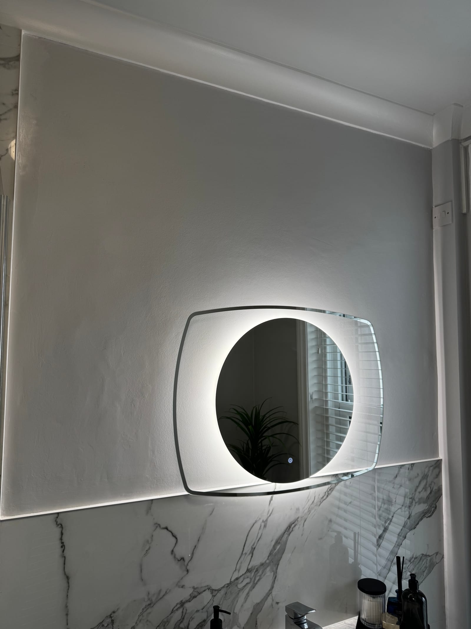 Refreshed bathroom with backlit mirror and new décor