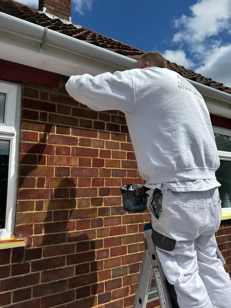 Decorator finishing exterior woodwork and soffits